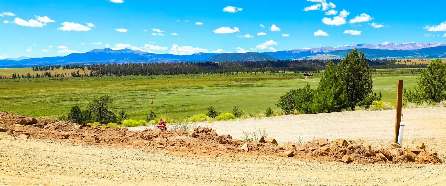 Photo: the South Park valley from a graded lot, with ranch land and mountains in the distance