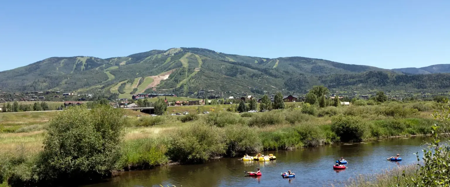 Photo: tubers on the Yampa River in Steamboat Springs with the ski runs behind